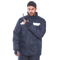 Person wearing Navy cold store jacket. Jacket has a hi vis band across the chest and thermal hand area to cover the hands.