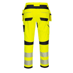 Back of Portwest PW3 Flame Resistant Hi-Vis Holster Trousers in fluorescent yellow and two reflective strips on legs below black knee patches. Pocket on side of leg and two pockets on bottom with black band at bottom. Belt loops on waistband.