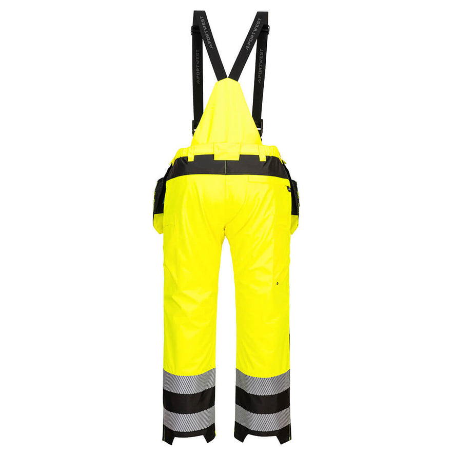 Back of Portwest PW3 Hi-Vis Rain Trousers in yellow with black panels on waistband, ankles and straps over shoulders. Reflective strips on ankles and pockets on bottom and hips attached to waist band.