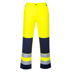 Yellow portwest Seville hi vis trousers. Trousers have kneepad pockets. side pockets and hi vis bands. Bands are on the ankles and there is orange contrast on the knee pads and ankle area.