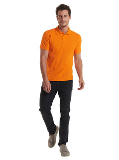 Person wearing Uneek Clothing UC101 220GSM Classic Poloshirt in orange with short sleeves, collar and three button plackett.