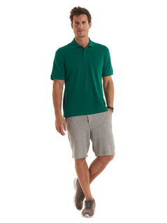 Person wearing Uneek Clothing UC114 180GSM Men's Polo Shirt with short sleeves, collar and three button plackett in bottle green.