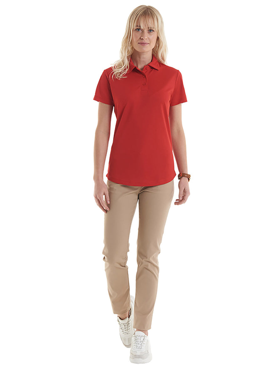Person wearing Uneek Clothing UC126 Ladies Ultra Cool Poloshirt 100% Polyester with short sleeves in red with red buttons and collar.