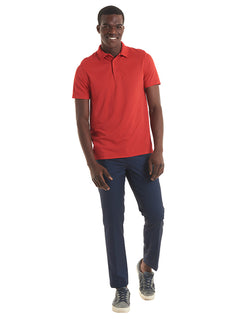 Person wearing Uneek Clothing UC127 200GSM Mens Super CoolWorkwear Poloshirt with short sleeves in red with red buttons and collar.