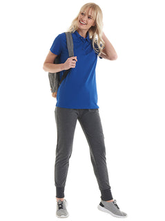 Person wearing Uneek Clothing UC128 Ladies Super Cool Workwear Poloshirt with short sleeves in royal blue with royal blue buttons and collar.