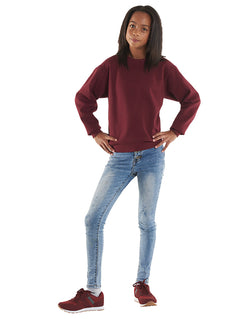 Person wearing Uneek Clothing UC202 300GSM Childrens Sweatshirt long sleeves and round neck in maroon with elasticated bottom.