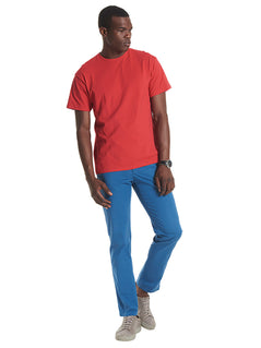 Person wearing Uneek Clothing UC302- 200 GSM Premium T-shirt with short sleeves and round neck in red.