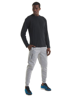 Person wearing Uneek Clothing UC314 180 Mens Long Sleeve T-shirt with round neck in black.