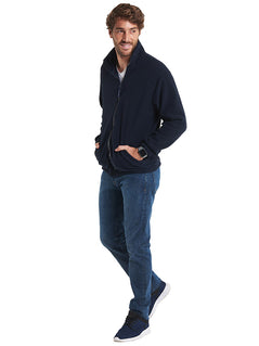 Person wearing Uneek Clothing UC604 300GSM Classic Full Zip Micro Fleece Jacket in navy with full zip fastening and and two lower front pockets.
