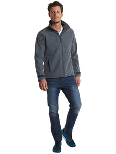 Person wearing Uneek Clothing UC611 Premium Full Zip Soft Shell Jacket in light grey with full zip fastening and and a pocket on the right chest and two lower front pockets.
