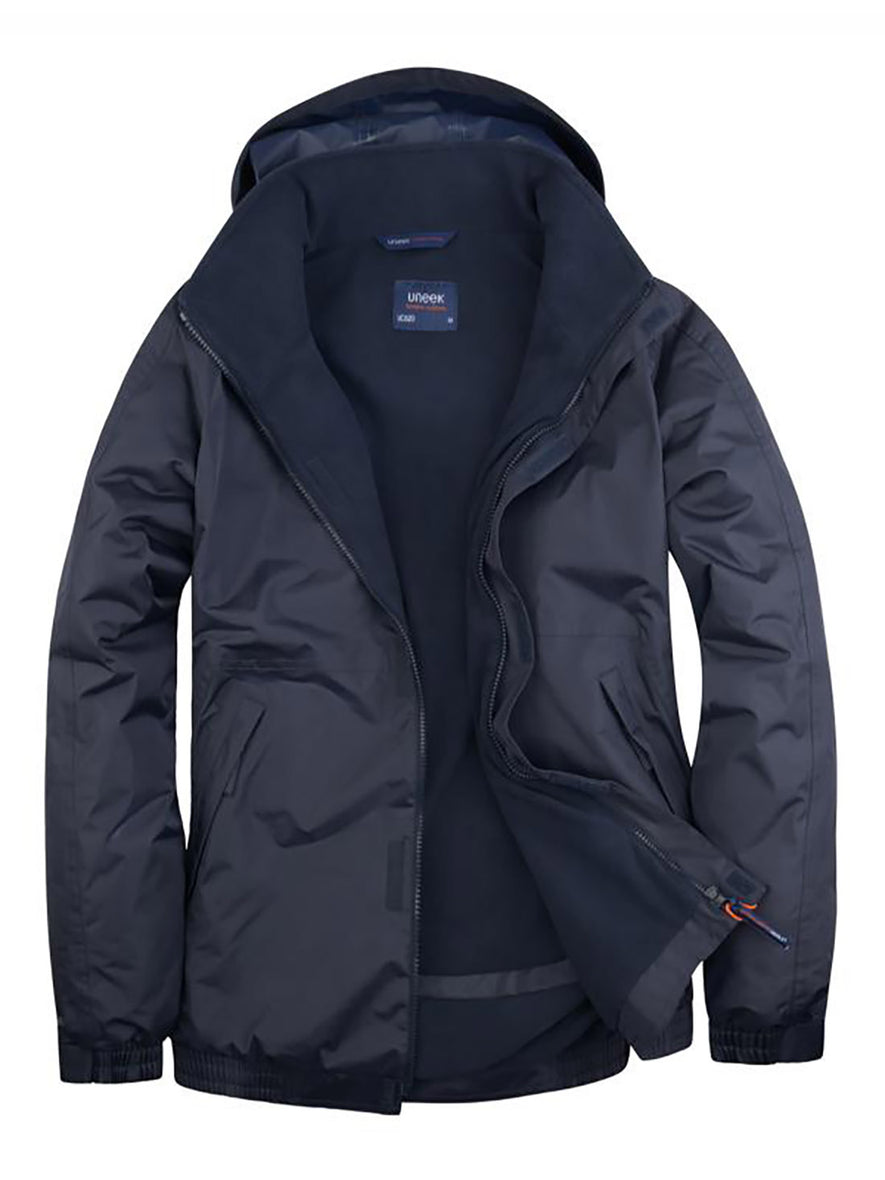 Uneek Clothing UC620 - Premium Outdoor Jacket in navy with hood with navy fleece lining, full front zip and flap with velcro, two front lower pockets with flap concealed zip.
