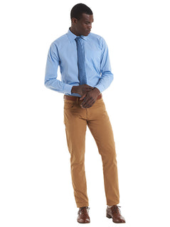 Person wearing Uneek Clothing UC713 Men's Tailored Fit Long Sleeve Poplin Shirt in light blue with pocket on left chest, collar and light blue buttons down front.