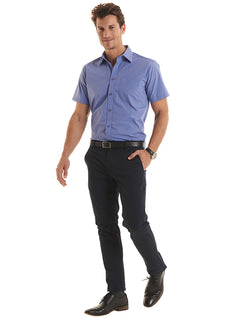 Person wearing Uneek Clothing UC714 - Men's Tailored Fit Short Sleeve Poplin Shirt in mid blue with pocket on left chest, collar and mid blue buttons down front.