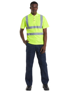 Person wearing Uneek Clothing UC805 - Hi-Viz Polo Shirt in yellow with two strips of reflective tape across chest and one over each shoulder, collar with three button plackett.
