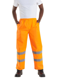 Person wearing Uneek Clothing UC807 Hi-Viz Trouser in orange with two strips of reflective tape on lower legs, elasticated waist and two side pockets.