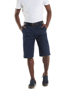 Person wearing Uneek Clothing UC907 Men's Cargo Shorts in navy with belt loops, button and zip fastening at waist, two side pockets and two pockets on side of legs with flaps.