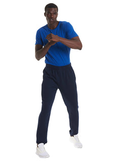 Person wearing Uneek Clothing UX9 The UX Jogging Pants in navy with elasticated waist and ankles.