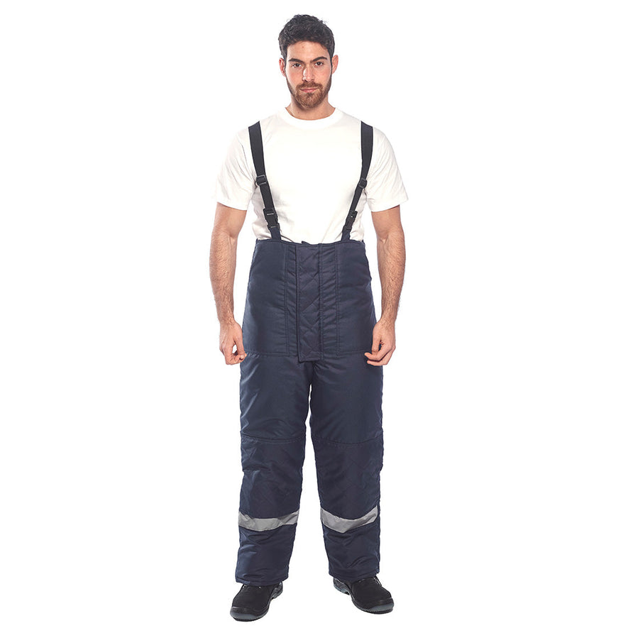 Person wearing Cold store trousers in navy with shoulder braces and hi vis ankle bands.