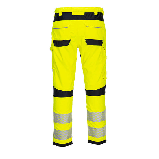 Back of Portwest PW3 Flame Resistant Hi-Vis Work Trousers in fluorescent yellow and two reflective strips on legs below black knee patches. Pocket on side of leg and two on bottom. Belt loops on waistband with black panel.