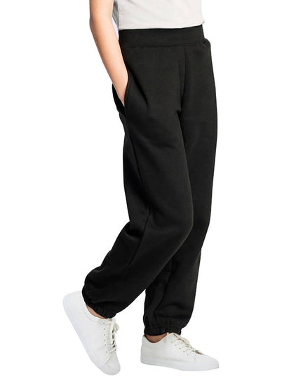 Person wearing Uneek Clothing UC521 Childrens Jog Bottoms in black with pockets and elasticated waist. 